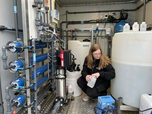 Containerized membrane filtration to remove micropollutants. An engineer is taking water samples.